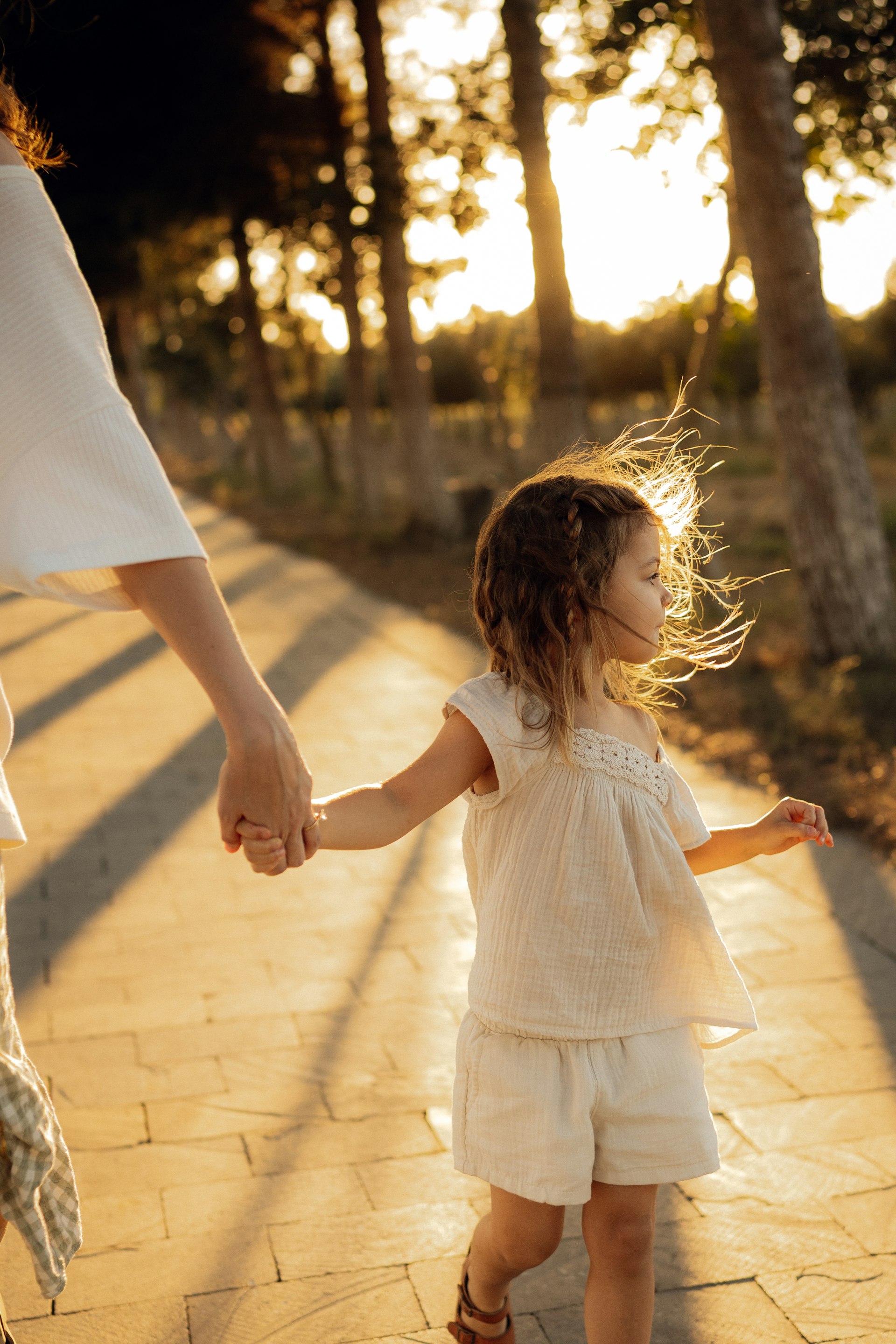 A parent and child holding hands