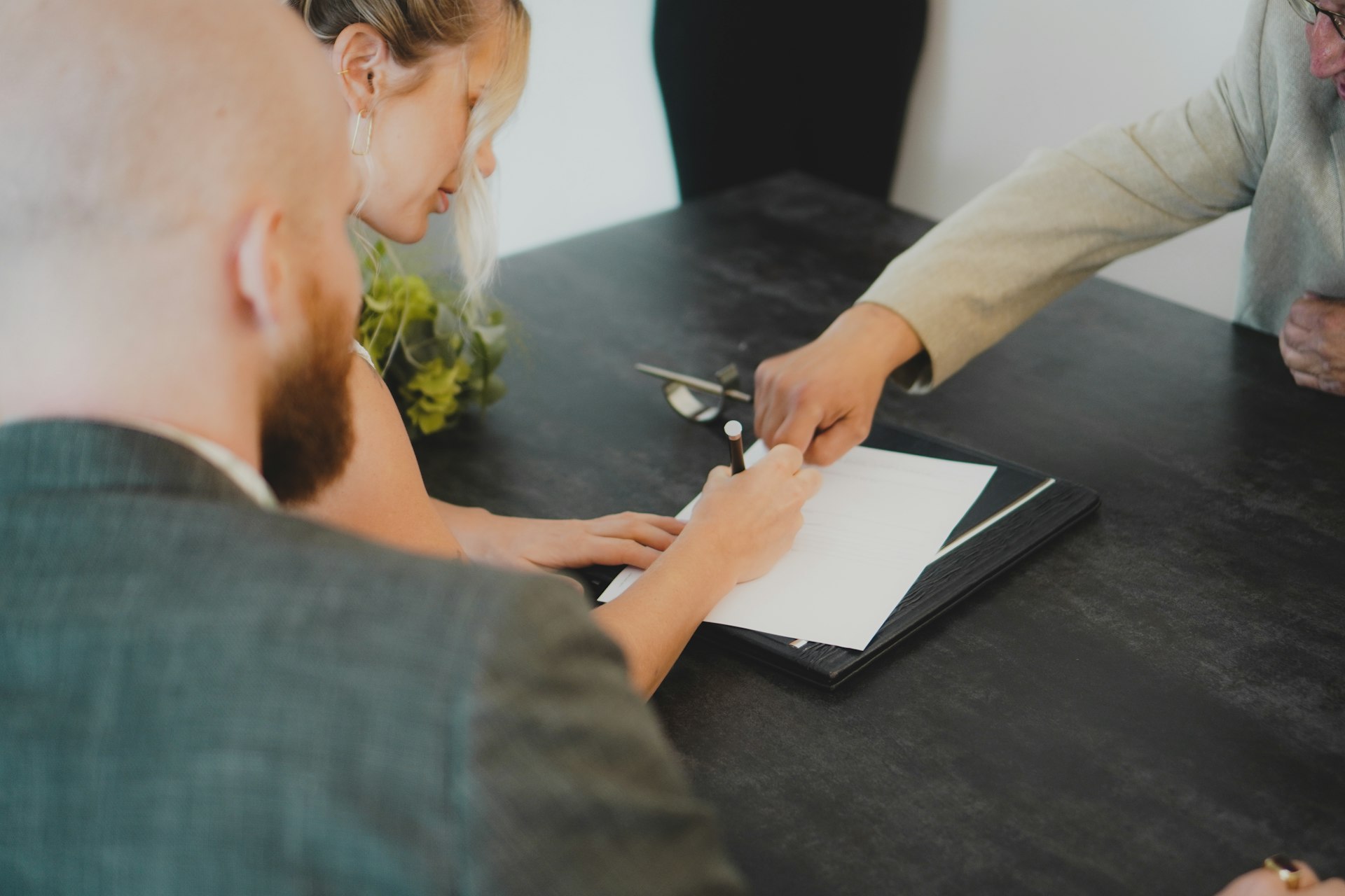 Wedding rings resting on a signed contract